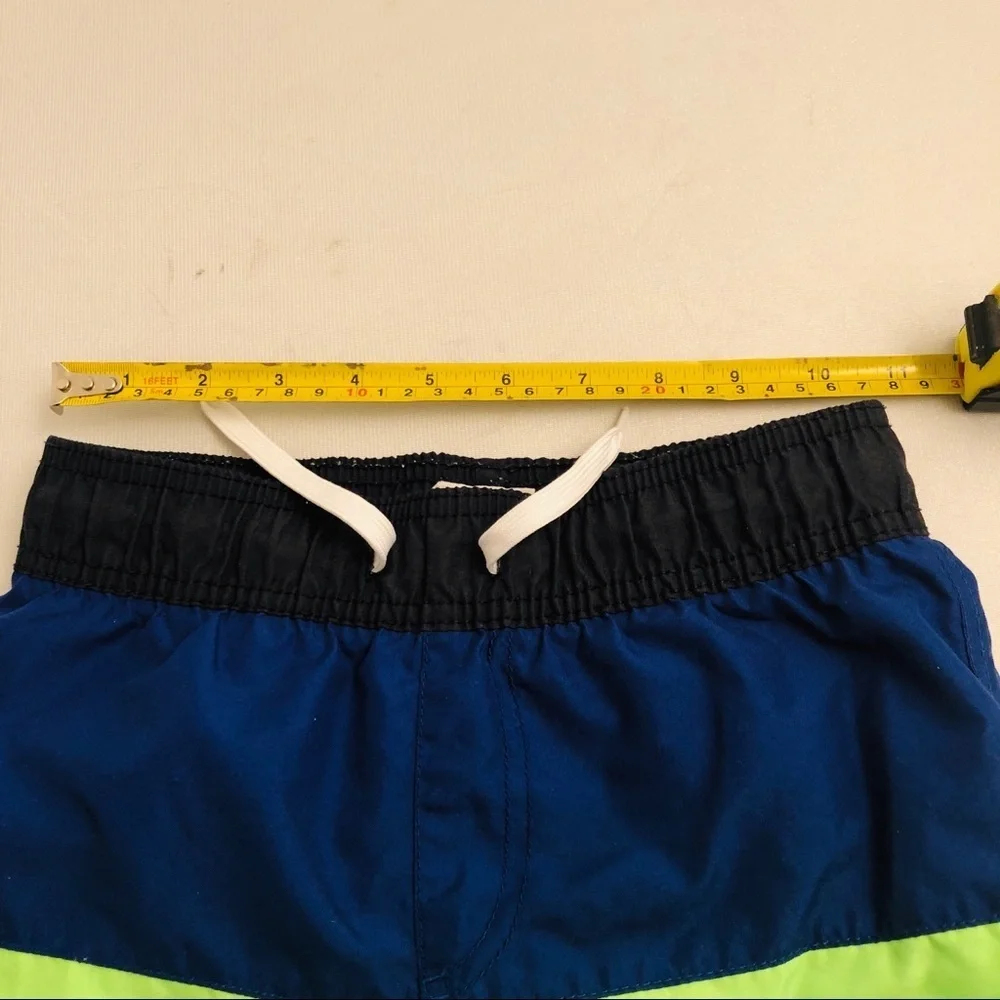 The Children’s Place blue and neon green swim trunks